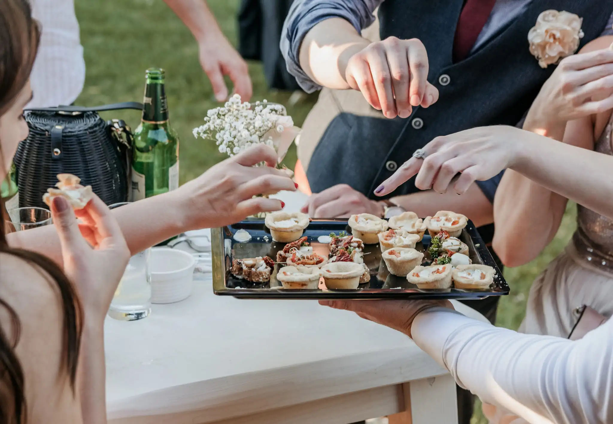 Group of friends eating finger food at a wedding reception