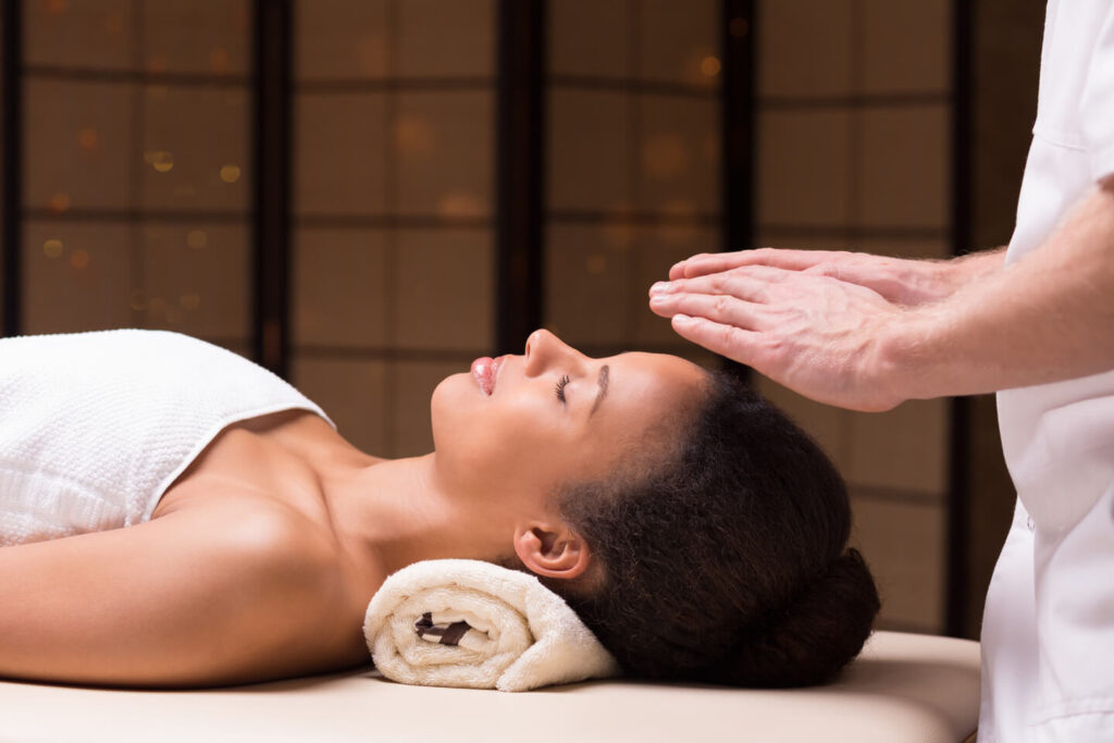 Physiotherapist Treating Woman With Bioenergy Therapy