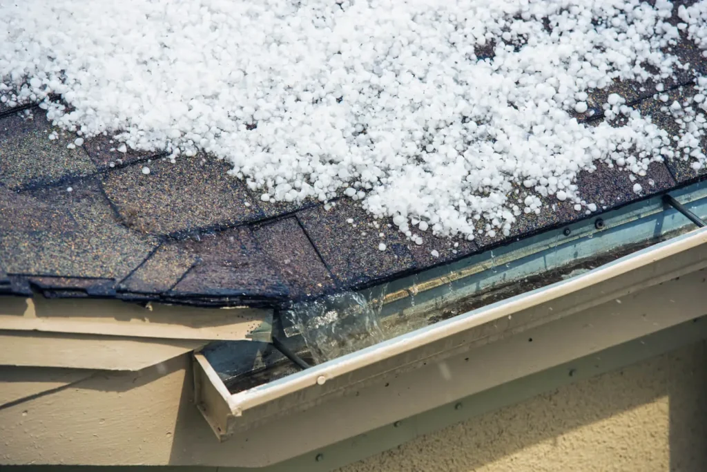 Hail Covered Roof and Gutters with Water Flowing