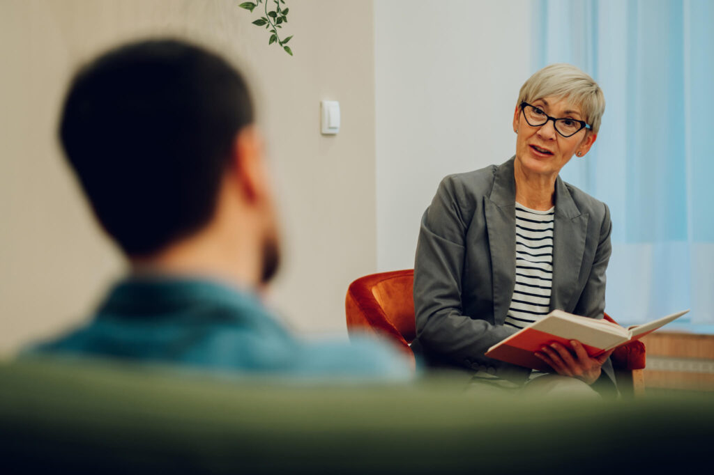 Woman Talks with Patient During Therapy Session
