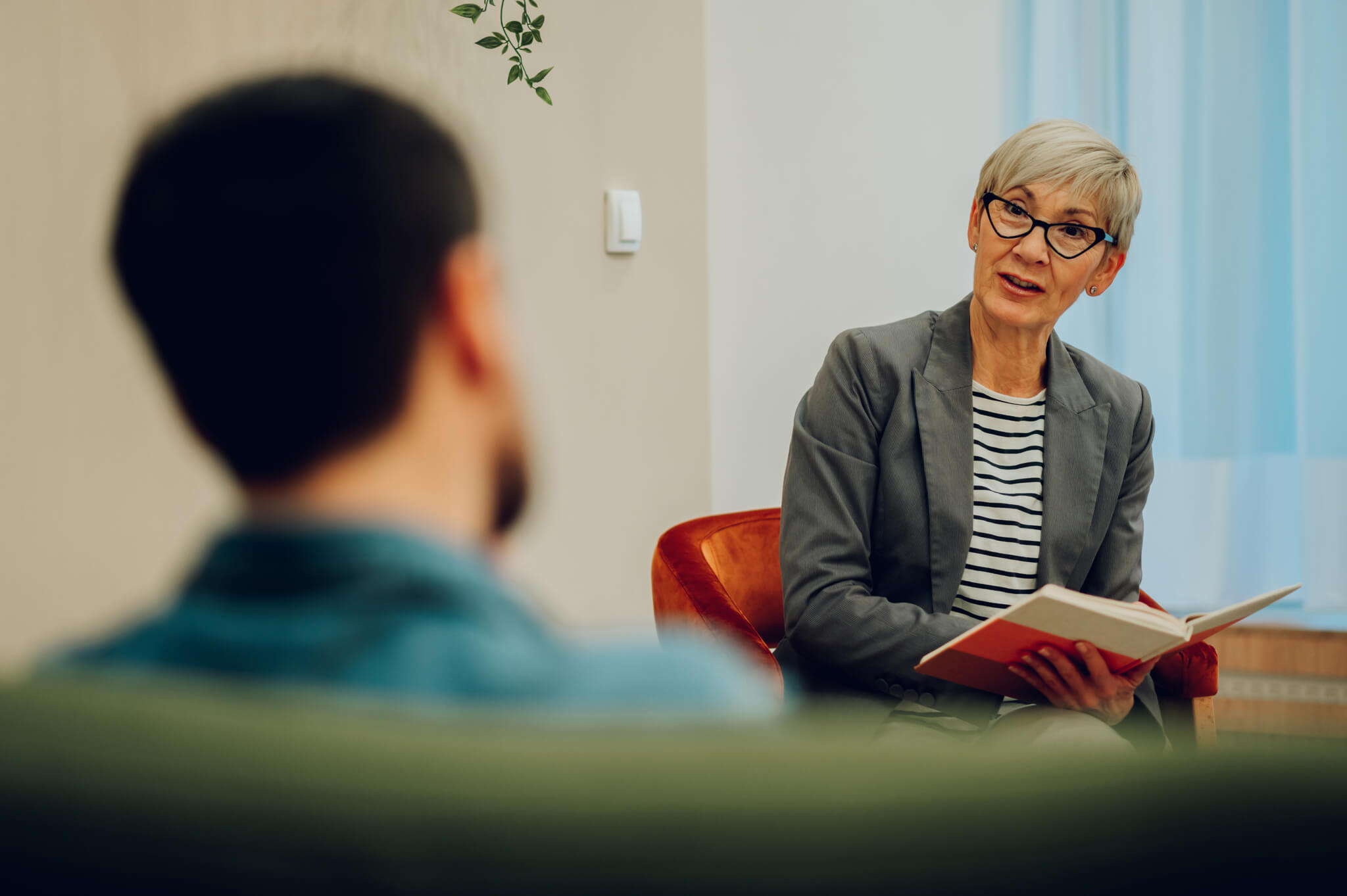 Woman Talks with Patient During Therapy Session