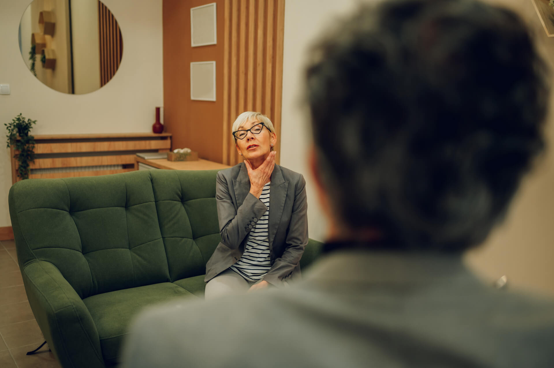 A senior female client is having an introjection while sitting in a doctor's office