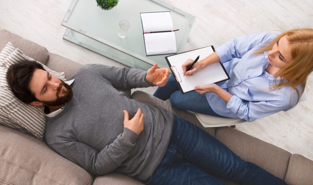 Man Lying on Couch Talking to Therapist